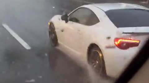 Woman Drives Along Watching a Movie