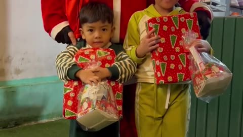 Children receive gifts from Santa Claus:Merry Christmas (p2)