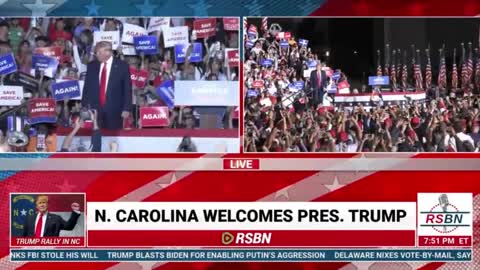 Trump throws MAGA hats to the audience as he takes the stage in North Carolina.