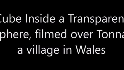 Cube à l'intérieur d'une sphère transparente, filmé au-dessus de Tonna, un village du Pays de Galles