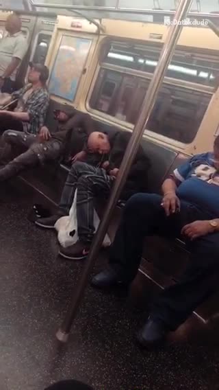 Three guys in a row asleep on subway train