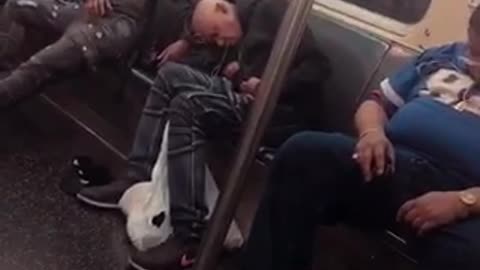 Three guys in a row asleep on subway train