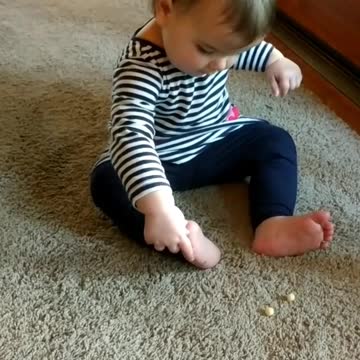 Flexible Baby Girl Eats Kix Cereal With Her Toes