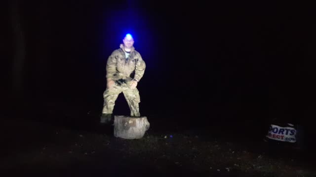 Position and light test before chopping firewood at night