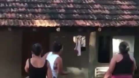 Crazy child climbs on the roof of the house