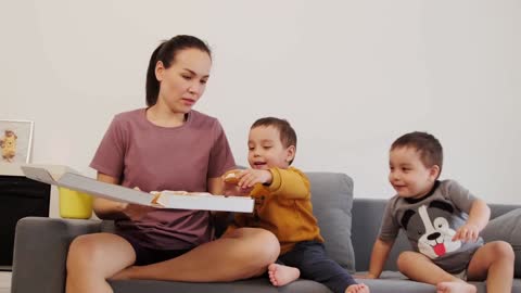 mom giving a snack to her twins