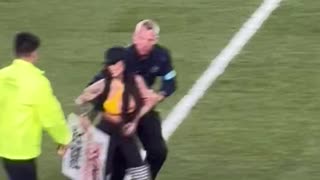 Woman runs onto field of Steelers-Jets game with Trump signs as he watches from Stands