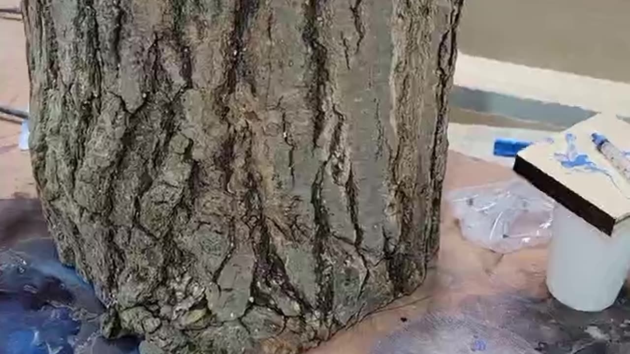 "Artistic Transformation: Filling the Oak Stump with Blue Varnish"