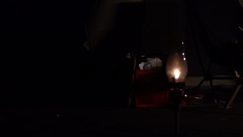 Light a lantern at night at a camping site. 2
