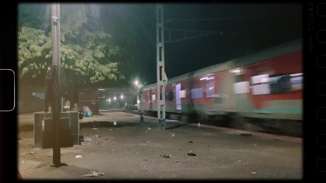 Indian Railways passes a village during its journey at night.