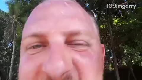 Drunk guy filming his face on beach