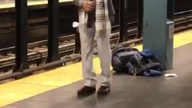 Man sunglasses scarf dancing subway train platform