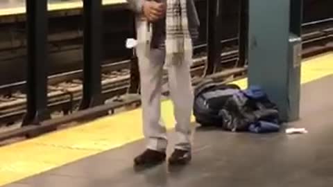 Man sunglasses scarf dancing subway train platform