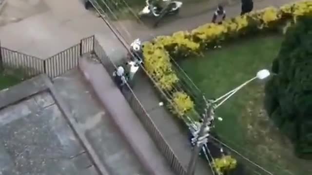 While the protester runs away from the police, other residents support him