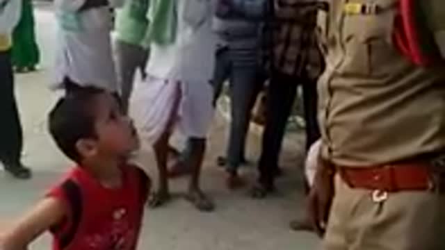 brave little boy stand front of police man