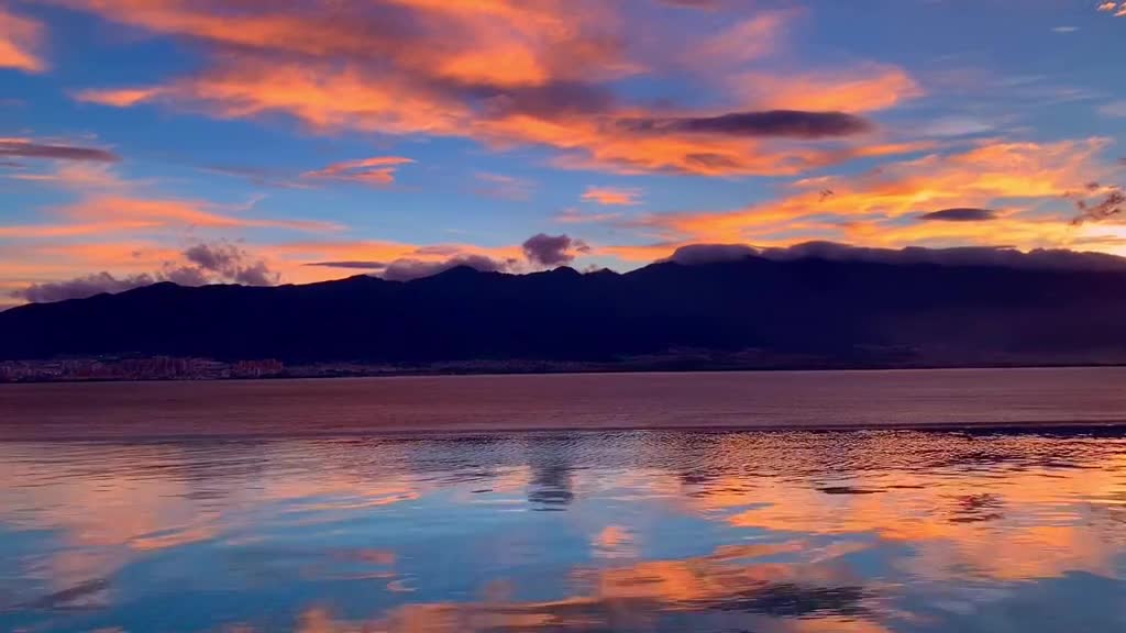 The western mountains are red as the sun sets
