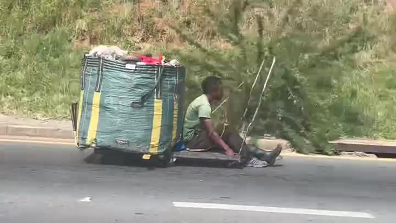 African boy races down highway in engine less cart- unbelievable!