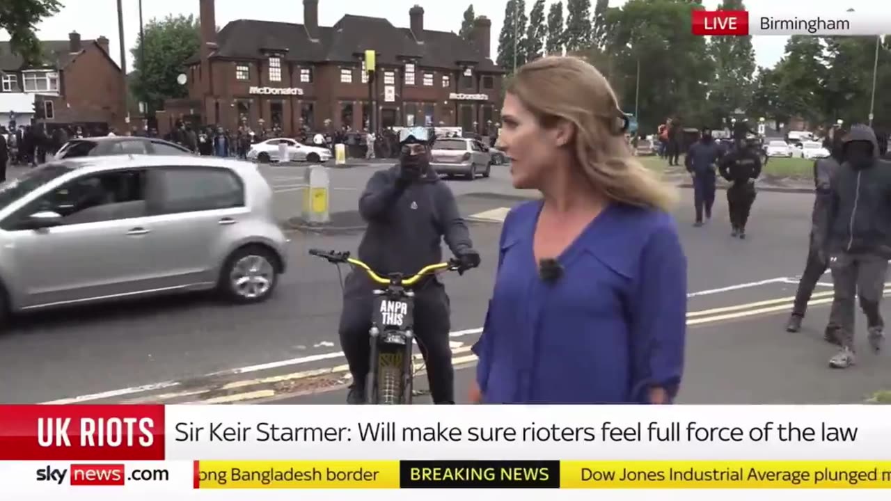 Sky News abruptly cuts its live feed as a mob of migrants surround its reporter: