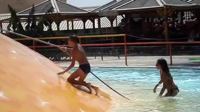 Kids climb up rope in water park