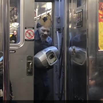 Man puts white powder on face and wears burger king crown pretending to be whopper guy on subway train