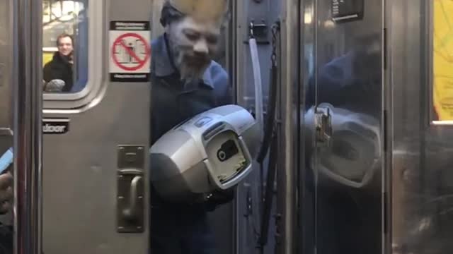 Man puts white powder on face and wears burger king crown pretending to be whopper guy on subway train