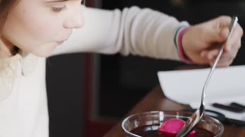 Soaking An Egg On Red Liquid For Coloring