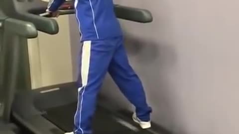 A man tries to run on a treadmill at the maximum speed