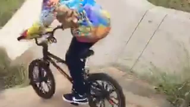 Kid in tye dye sweater crashes bike