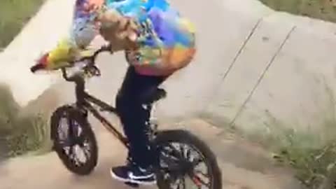 Kid in tye dye sweater crashes bike