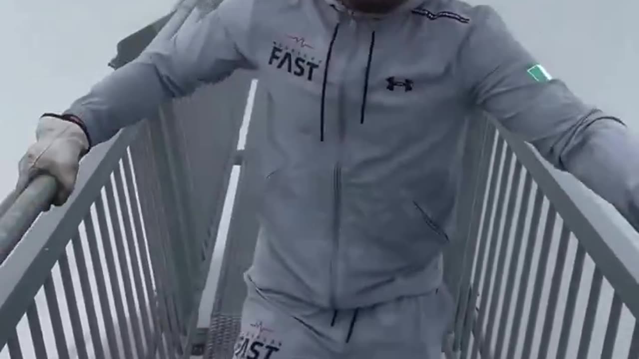 Conor McGregor crossing hanging mountain bridge in Switzerland