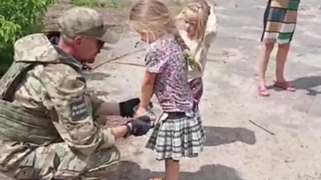 Soldier Gives Candy to Children