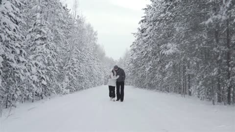 happy couple at winter forest