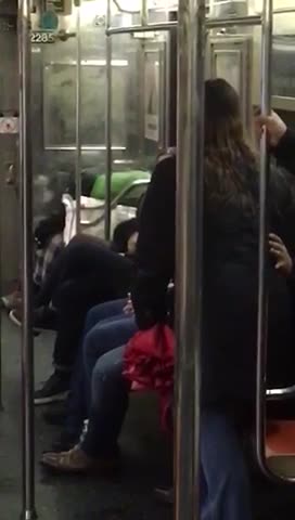 Woman yelling at guy telling him to turn off his recording or his cigarette on the subway