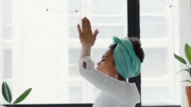 Woman Meditating on Her Bed