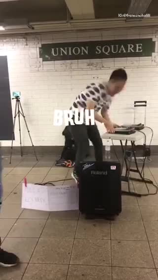 Guy in black and white shirt playing music