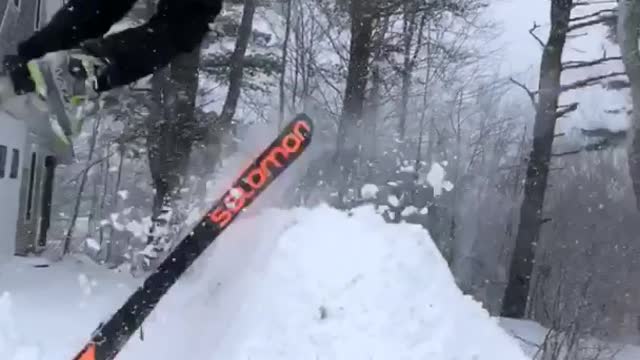 Black truck pulls skiing man fails on snow ramp