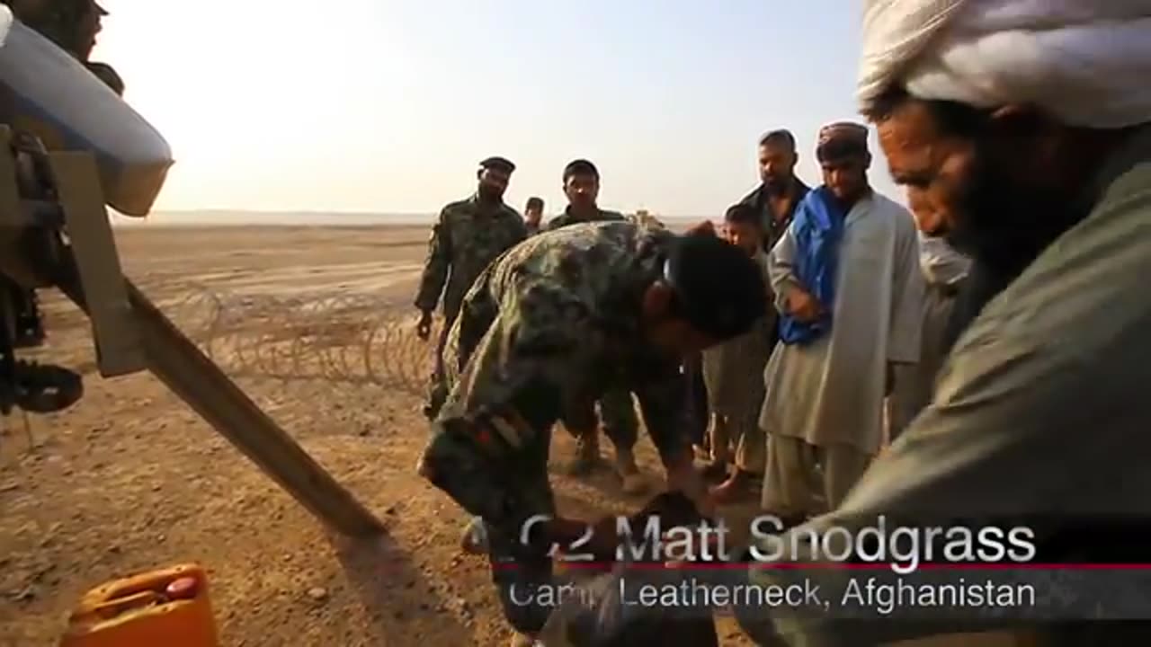 Marines Afghan soldiers distribute food to locals