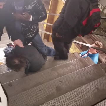 Man tries to get in a fight and gets pinned down on subway stairs