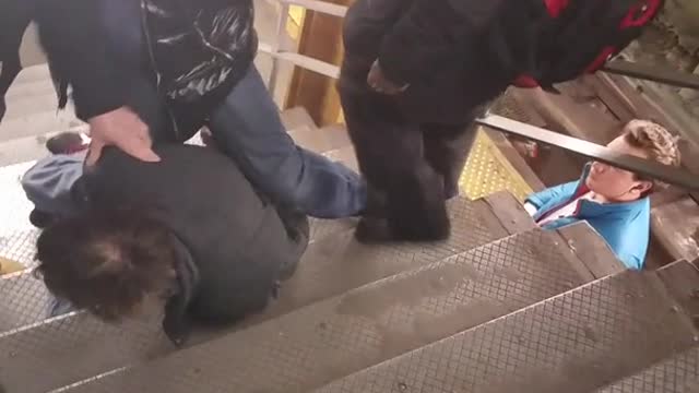 Man tries to get in a fight and gets pinned down on subway stairs