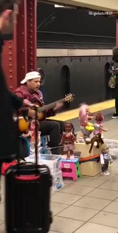Man sings la bamba in subway with dancing dolls