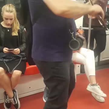 Man in blue plays violin on subway