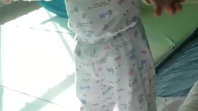 This is a video of a baby fanning herself with her best effort.