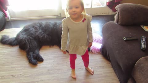 Little girl teaches dog to be a cheerleader