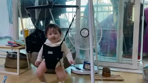 Exciting baby and cat looking at her