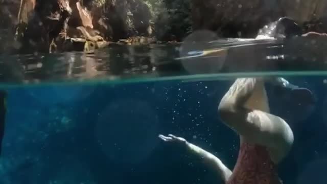 Beauty diving and dancing with fish.