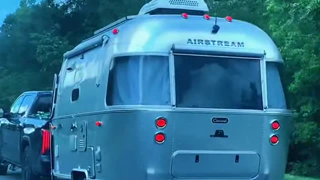 Justin Bieber in his grey wolf camper and Tesla truck