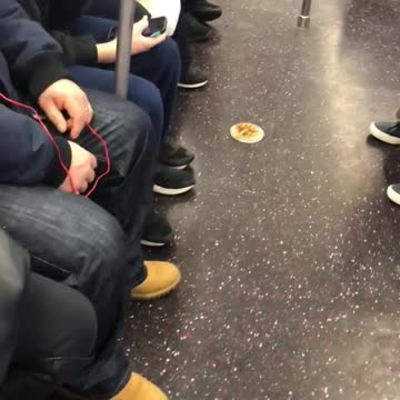 Lady eating off of small plate on subway floor