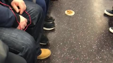 Lady eating off of small plate on subway floor