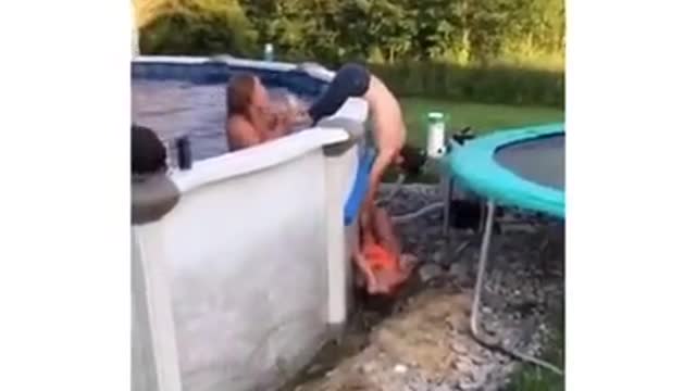 Girl tries to dive in the pool by jumping on the trampoline