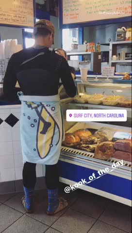 Guy in wetsuit and blue socks at a cafe